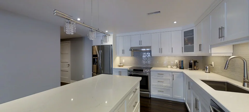 The kitchen and its island, in a finished Harmony basement in Aurora, captured in 360 degrees