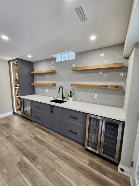 Basement finishing Pickering: the bar counter, the beverage fridges and the tile backsplash — built in East Gwillimbury