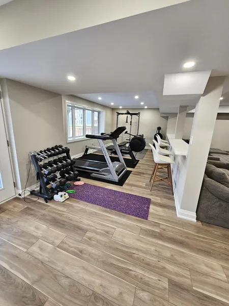 Basement home gym Innisfil, open to the family room — built in East Gwillimbury