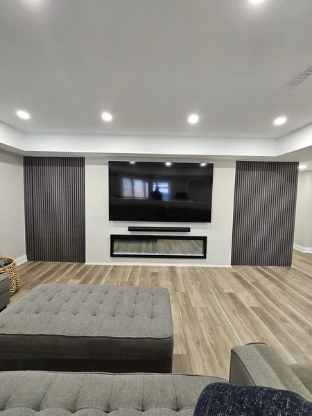 Basement remodeling Pickering: the media wall seen from the sectional — built in East Gwillimbury