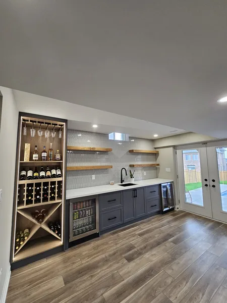 Basement renovation Ajax: the bar's lit wine rack and floating shelves — built in East Gwillimbury