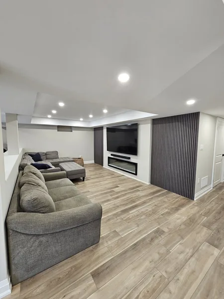 Basement renovation Whitby: the sectional facing the TV wall — built in East Gwillimbury