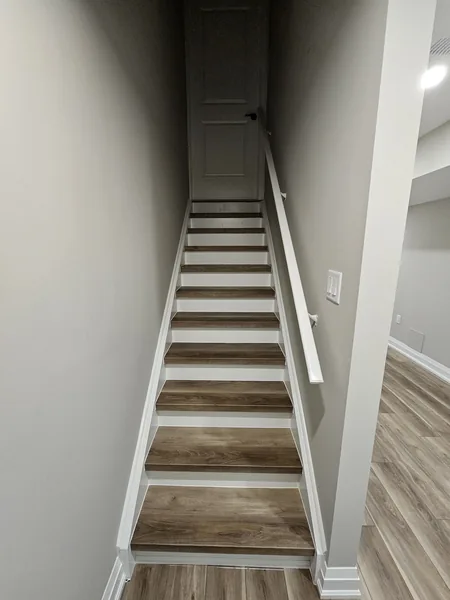 Basement stairs Barrie: treads matching the vinyl plank floor — built in East Gwillimbury
