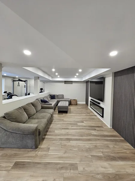 Finished basement Aurora: the family room, the sectional and the slat wall — built in East Gwillimbury