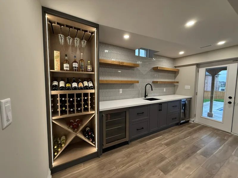 Finished basement Bradford: the wet bar, its lit wine wall and the walkout door — built in East Gwillimbury