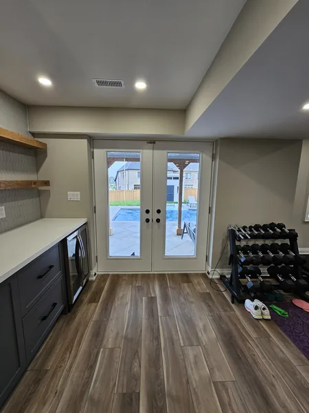 Finished basement Pickering: the walkout French doors beside the bar — built in East Gwillimbury