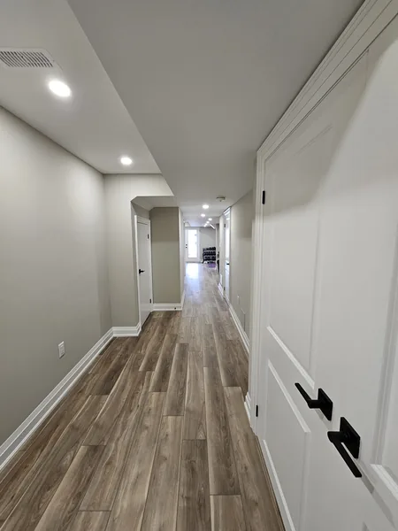 Finished basement Toronto: the hallway, showcasing the vinyl floor — built in East Gwillimbury
