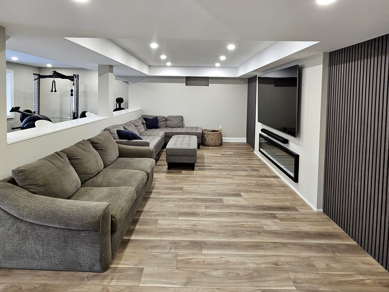Basement idea, the lounge and media wall: a finished basement in East Gwillimbury by Harmony Basements