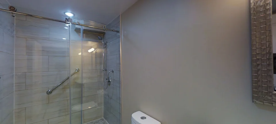 The bathroom: a glass shower, in a finished Harmony basement, captured in 360 degrees