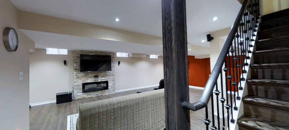The staircase: iron pickets and a rustic post, in a finished Harmony basement, captured in 360 degrees