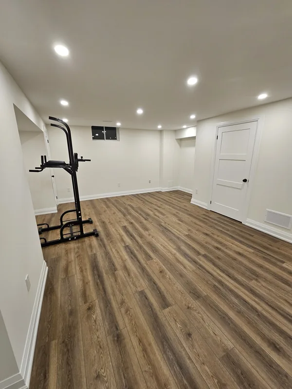 Basement finishing Georgetown: the home gym area of an Ancaster basement, by Harmony Basements — built in Hamilton