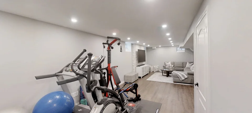 The gym and the bathroom entry, in a finished basement by Harmony Basements, captured in 360 degrees