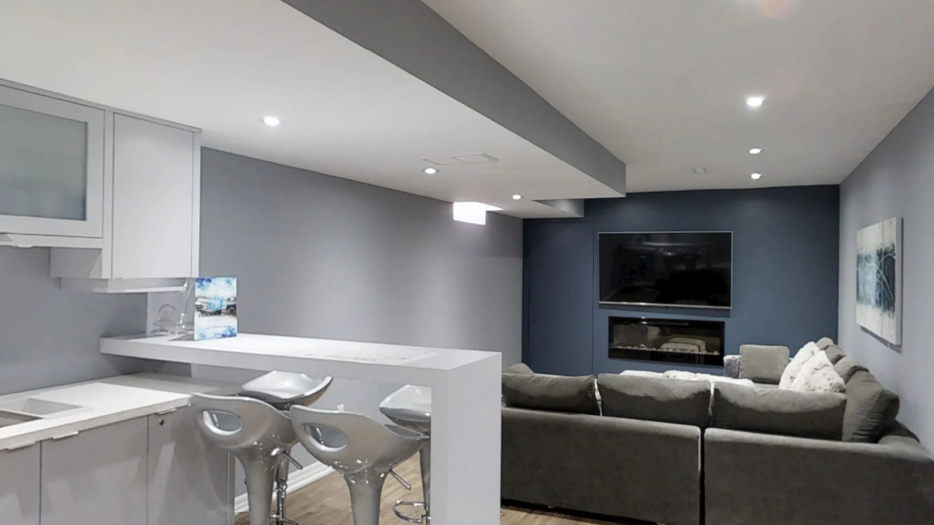 A finished basement in Maple: the wet bar and its breakfast peninsula, open to the family room