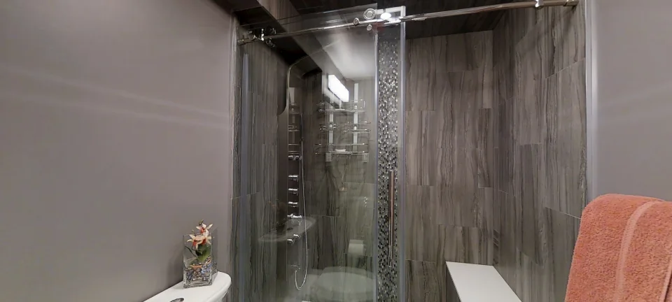 The bathroom: a glass shower, in a finished basement by Harmony Basements, captured in 360 degrees
