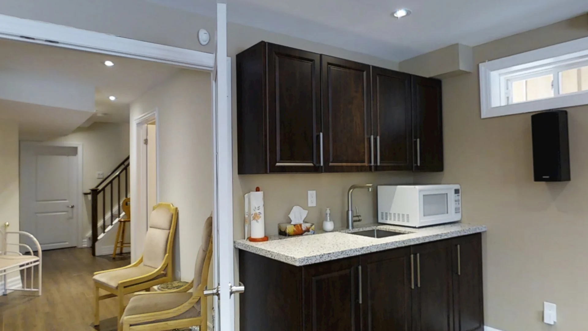 A finished Harmony walkout basement: the kitchenette, the TV and the family room
