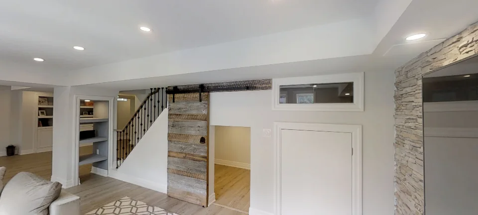 The rustic barn door and the stair, in a finished Harmony basement, captured in 360 degrees