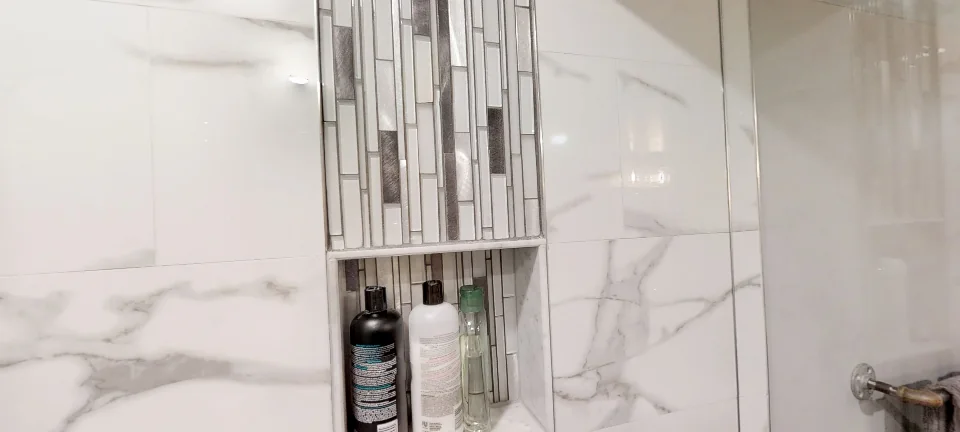 The shower: marble tile and a mosaic niche, in a finished basement in Oakville by Harmony Basements, captured in 360 degrees