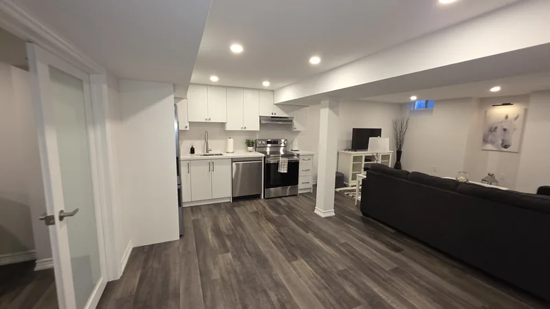 Open-plan basement remodel Thornhill: the French doors, the kitchen and the family room — built in Woodbridge