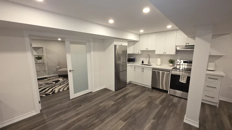 Basement remodeling Caledon: frosted-glass French doors to the office, beside the kitchen — built in Woodbridge