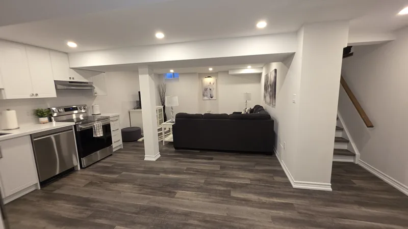 Basement renovation Caledon: the kitchen, the family room and the painted staircase — built in Woodbridge