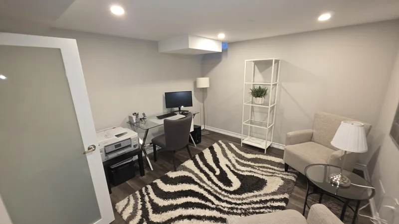 Basement finishing Nobleton: the home office behind the frosted French doors — built in Woodbridge