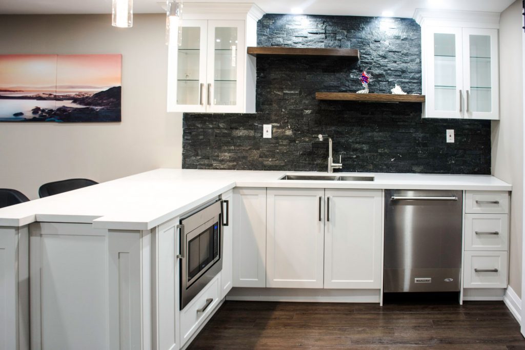 Basement finishing in Toronto: the wet bar with its floating stained-oak shelves, by Harmony Basements