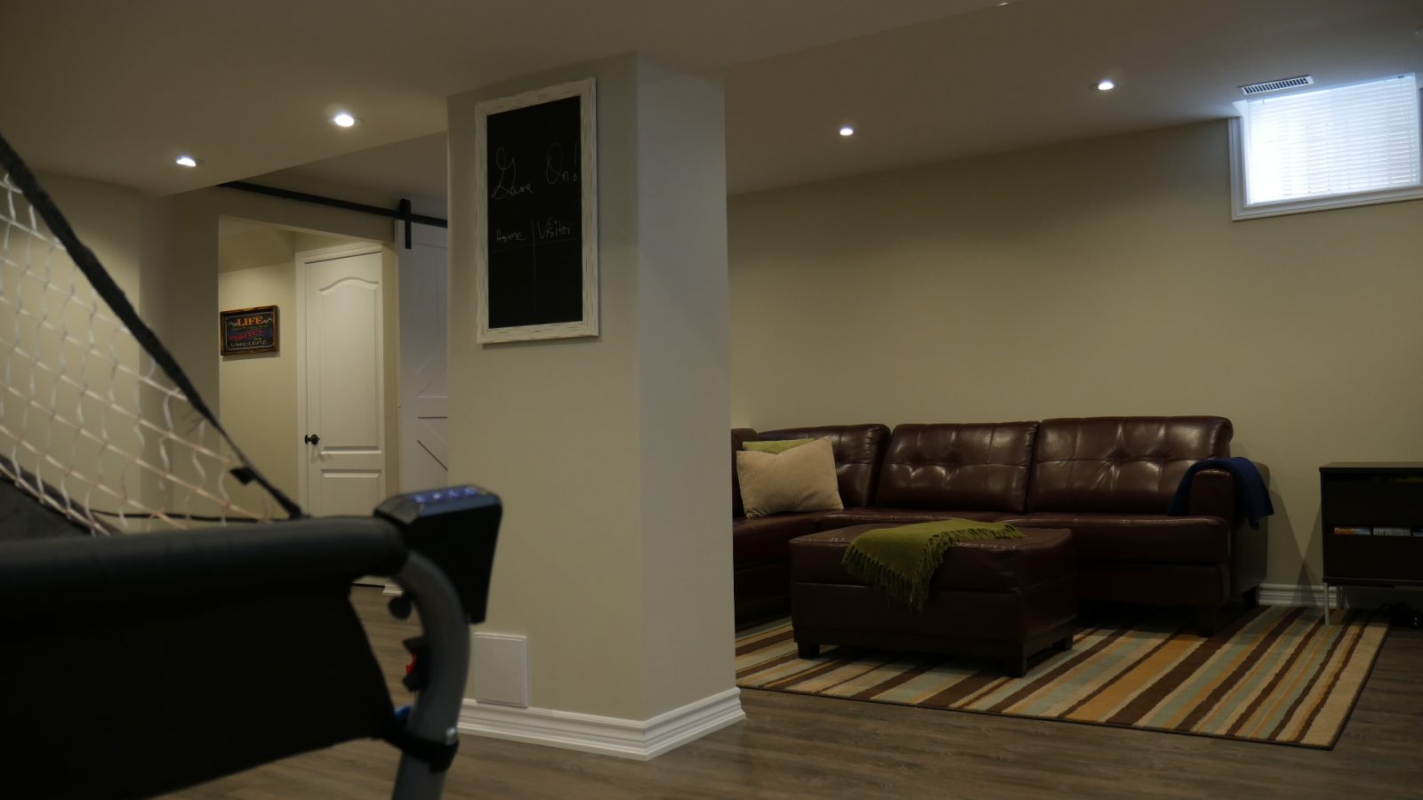 The family room in a finished basement by Harmony Basements