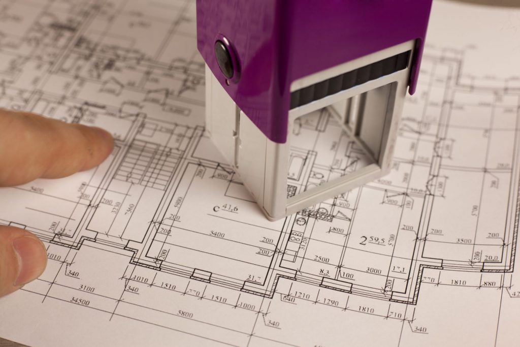 A building permit stamp on architectural drawings