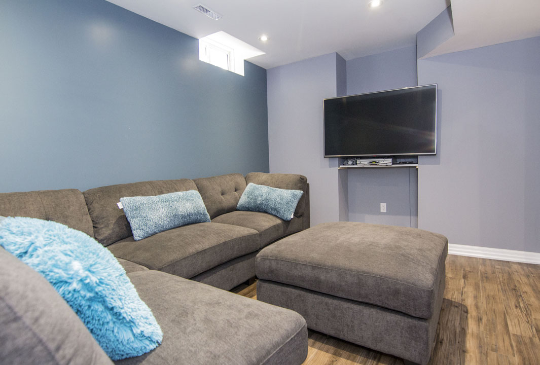 The lounge, from the sectional in a finished basement in Maple by Harmony Basements