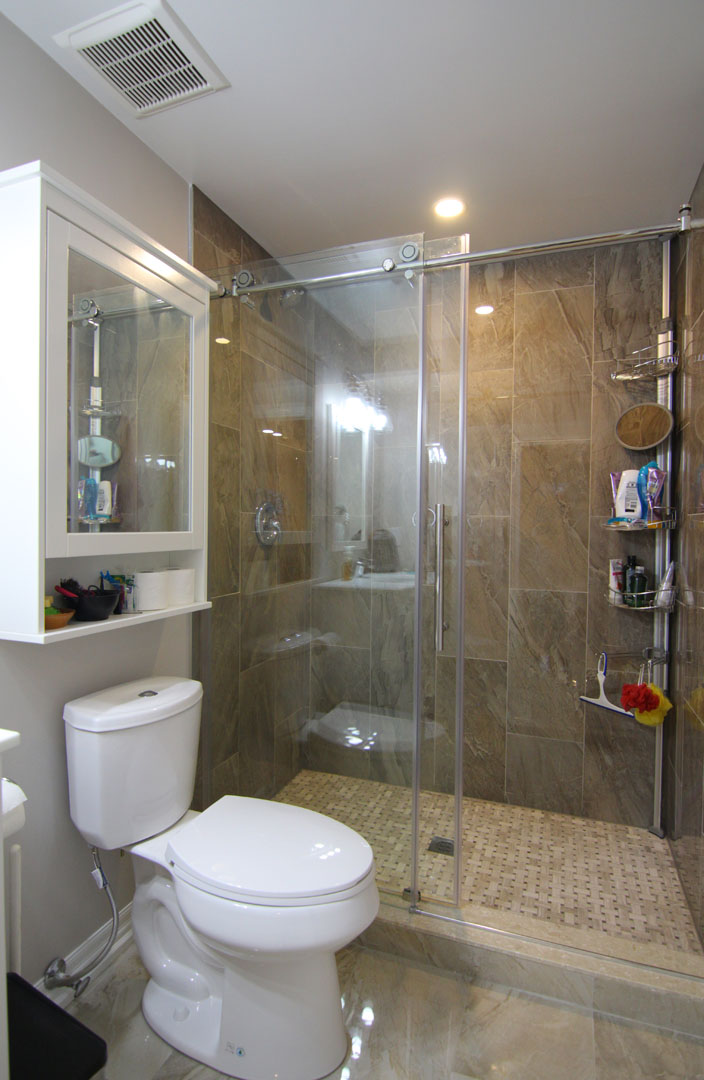 The bathroom: a walk-in glass shower in a finished basement in Burlington by Harmony Basements