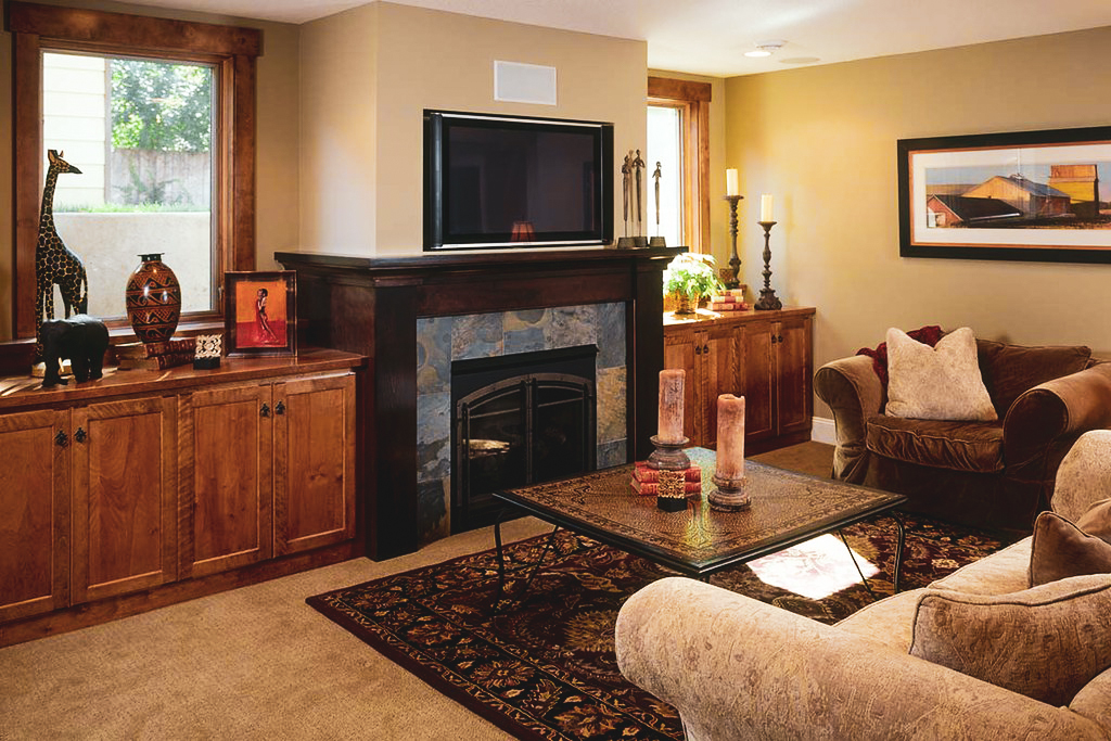 Renovated Basement living room with build in fire place and mounted tv harmony basements aurora