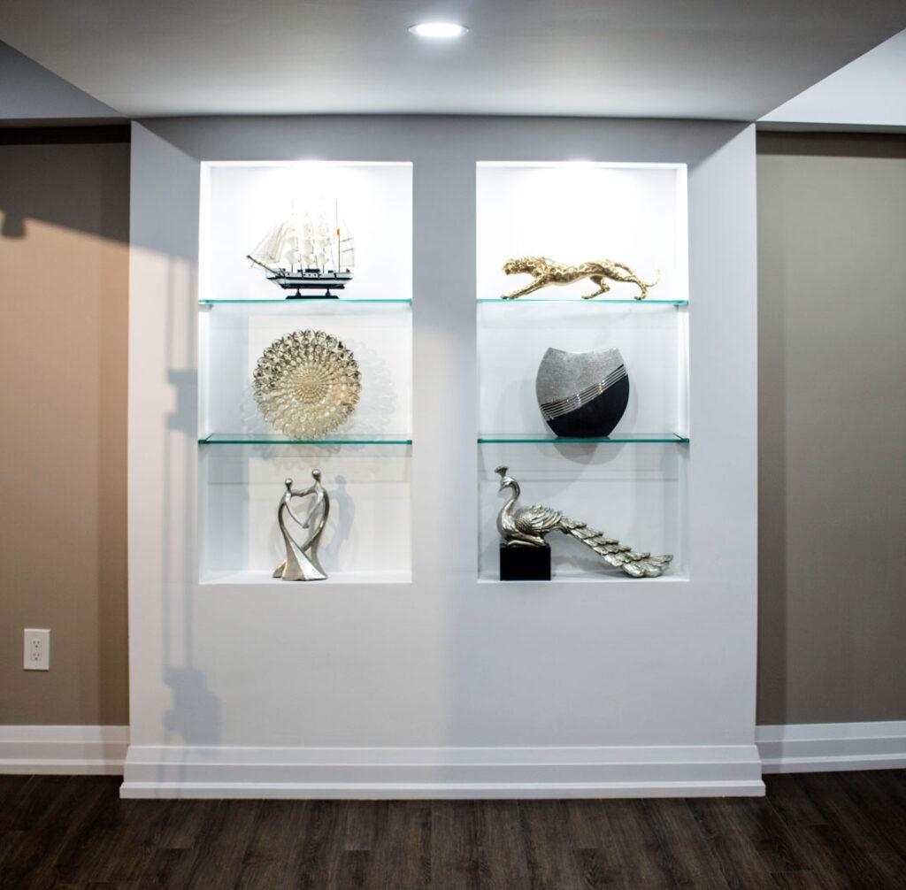 Lit display niches with glass shelves in a finished basement in Thornhill