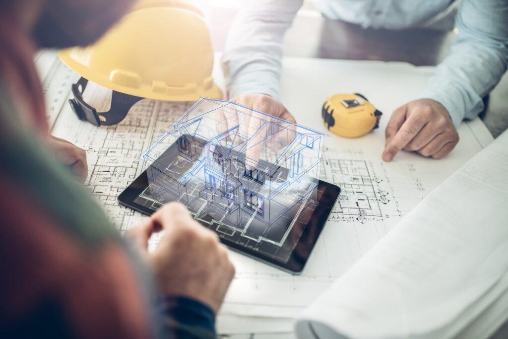 An engineer reviewing a 3D building model on a tablet