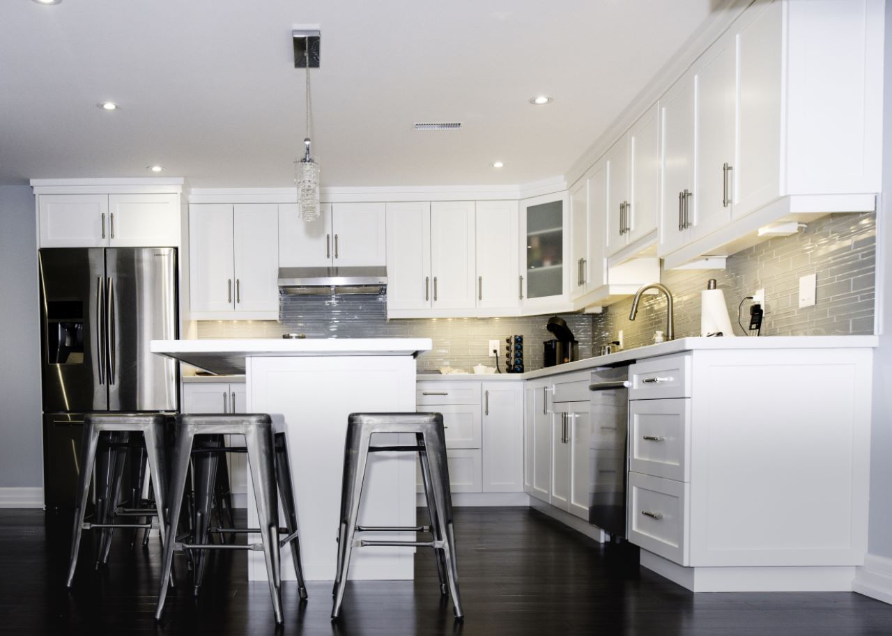 Basement kitchen island in Aurora: painted cabinets and an island, by Harmony Basements