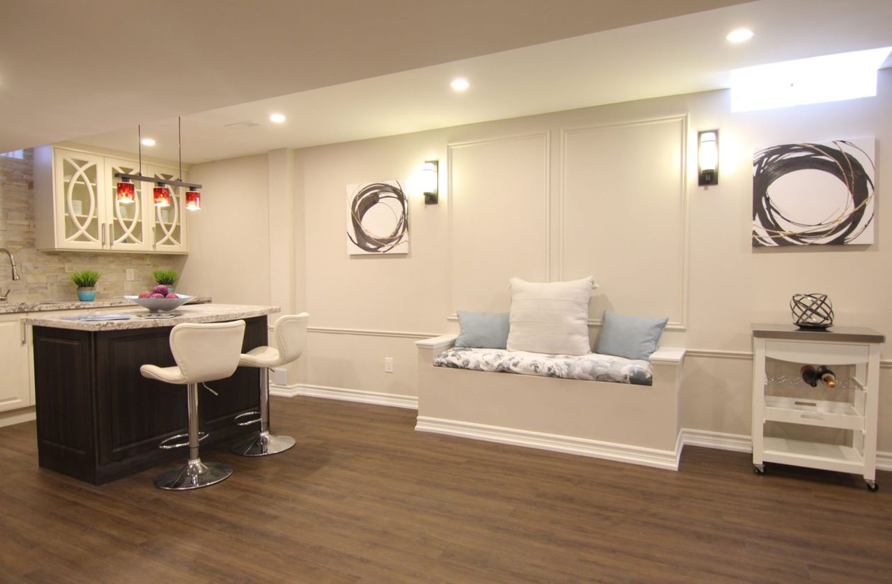 Basement kitchen island in King City: pendant lights and a window bench, by Harmony Basements