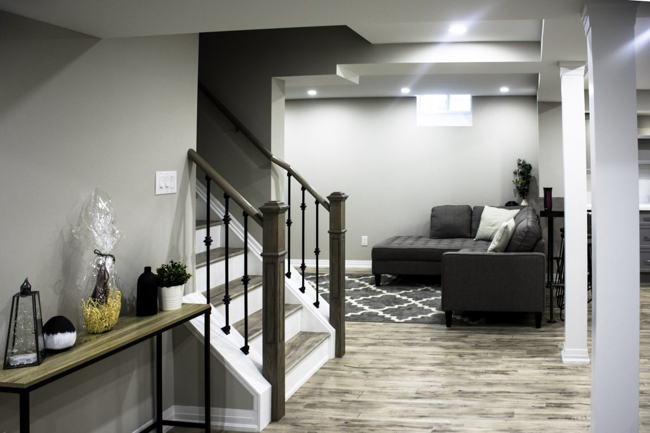 Basement open staircase in Thornhill: the staircase opened on both sides with new railings, by Harmony Basements