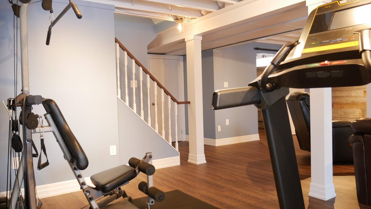 Basement staircase in Bradford: an open railing beside the gym, by Harmony Basements