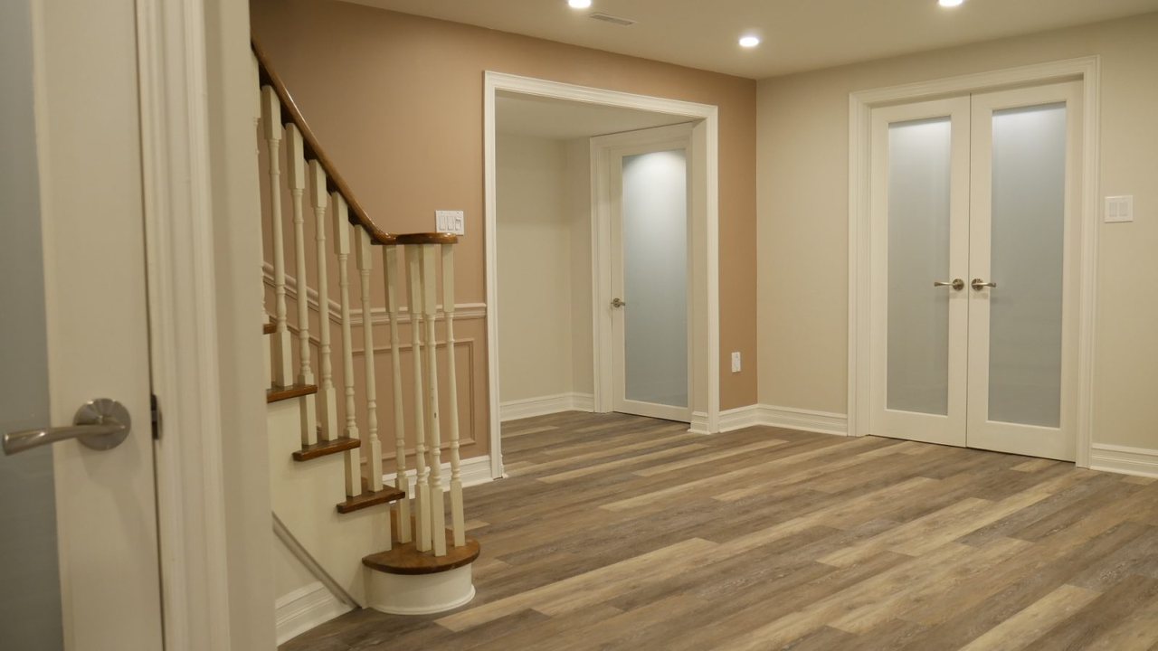Basement stair in Markham: the staircase and frosted-glass doors &mdash; a finished basement by Harmony Basements