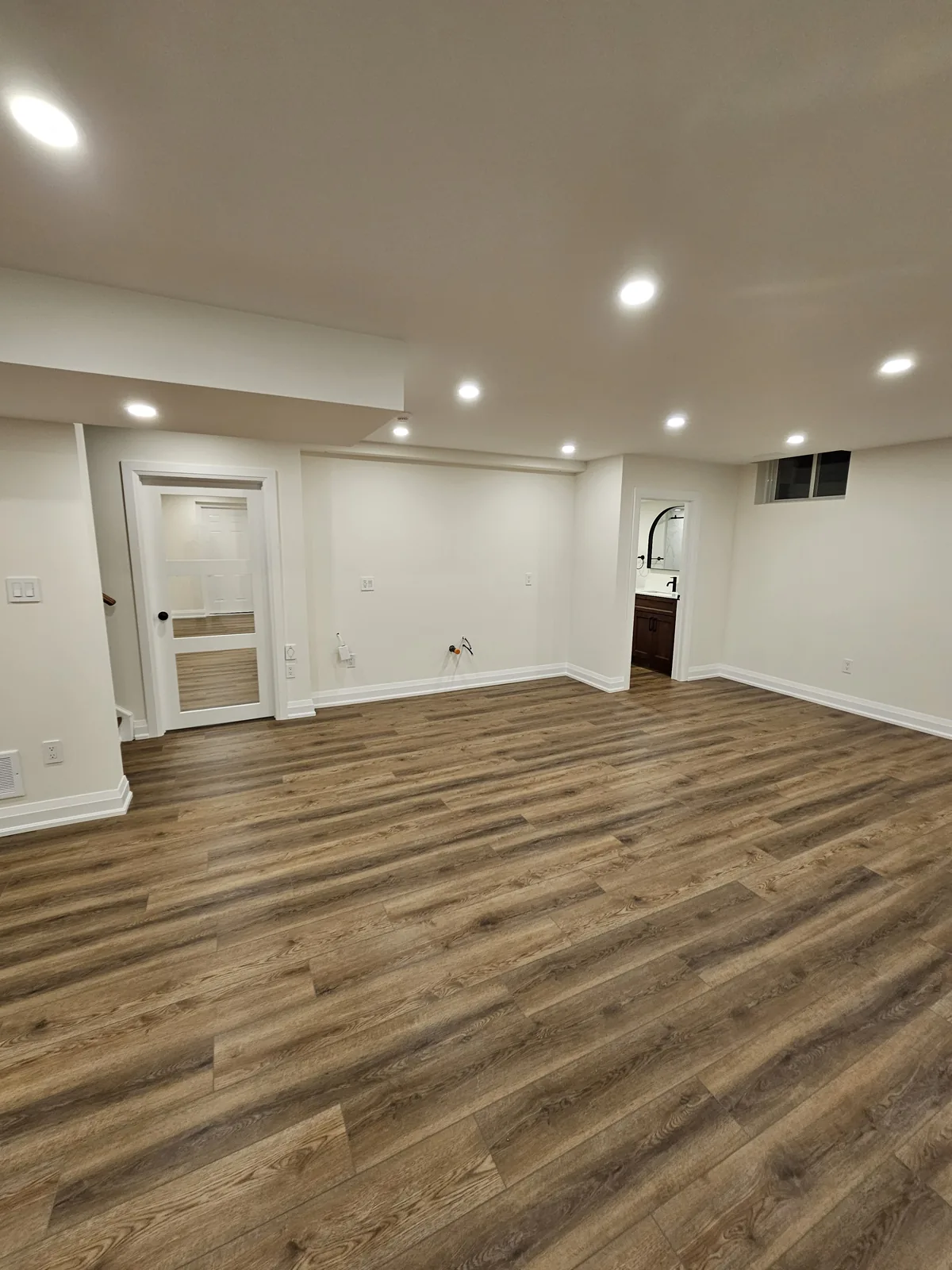 Basement vinyl plank floor in Ancaster, Hamilton: engineered vinyl over a mould-proof, waterproof subfloor, by Harmony Basements