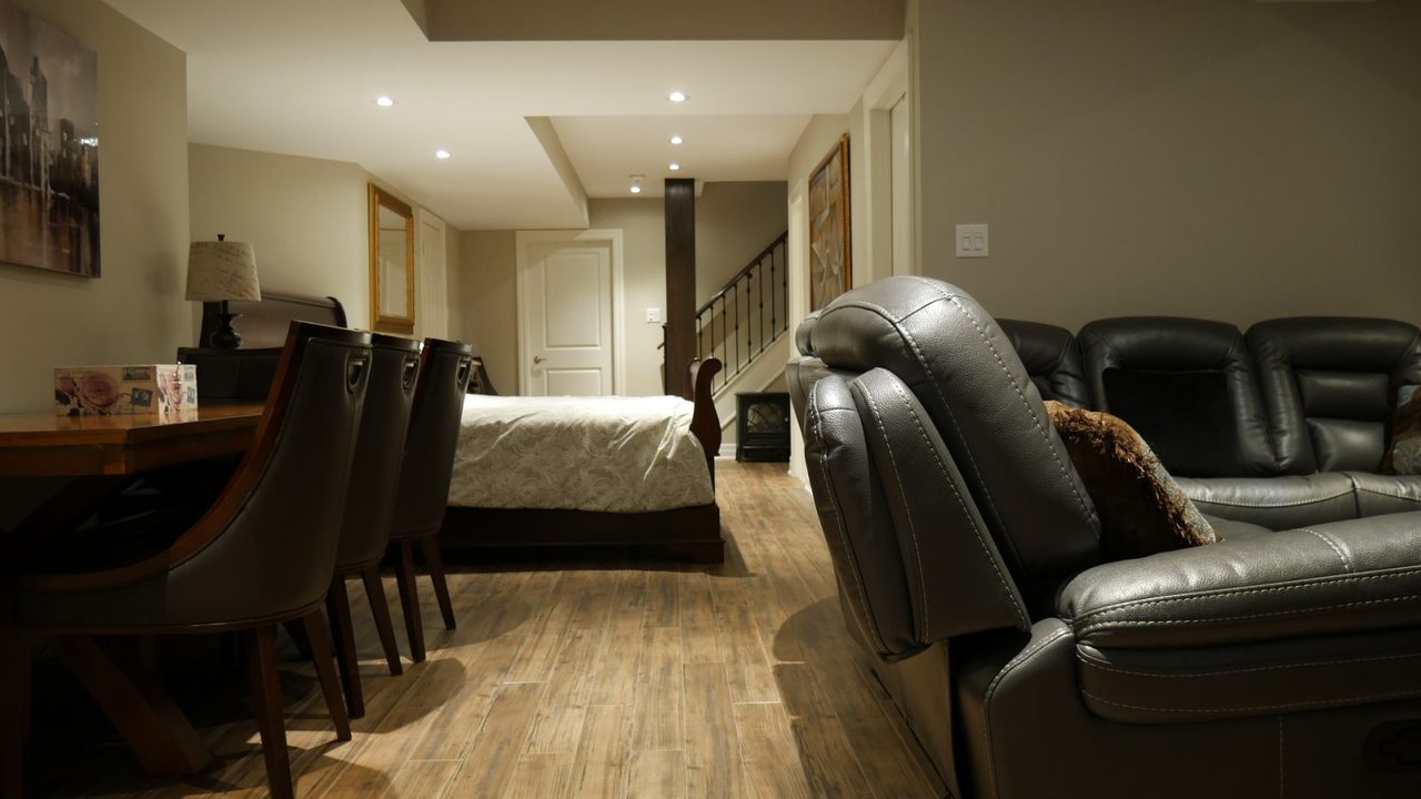 In-law suite ideas for Caledon: a family room, with the bedroom beyond &mdash; a basement apartment we built in King City